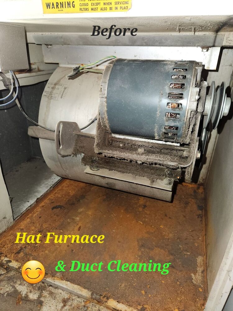 Furnace blower compartment with a belt-drive motor coated in thick grey dust and lint