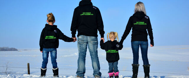 The family in Hat Furnace & Duct Cleaning hoodies looking out over a snowy field